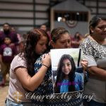 Esmeralda Bravo, center, holds a photo of her granddaughter, Nevaeh Bravo, one of the Robb Elementary School shooting victims, as she is comforted by Nevaeh