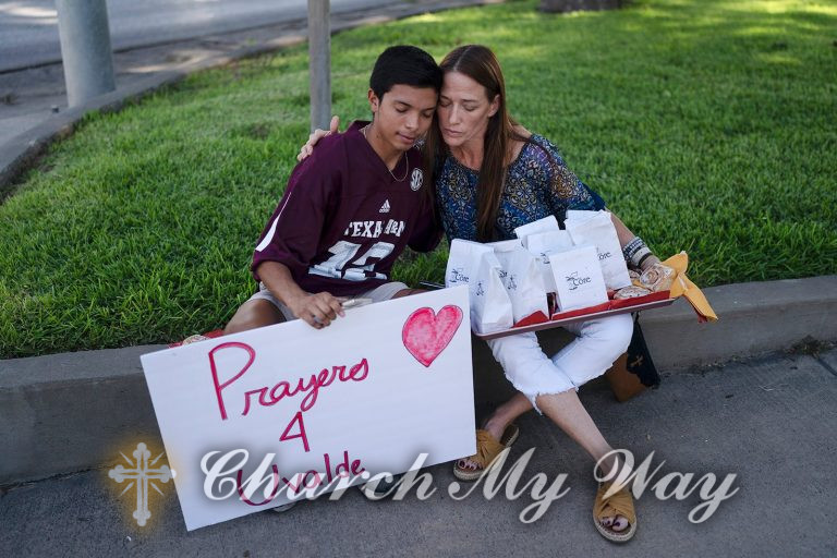 Diego Esquivel, left, and Linda Klaasson comfort each other May 25, 2022, as they gather to honor the victims killed in Tuesday