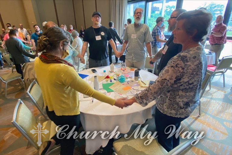 Mennonite Church USA delegates hold hands and sing after “A Resolution for Repentance and Transformation” was approved at the special session of the Delegate Assembly on May 29, 2022, in Kansas City, Missouri. Photo courtesy of MC USA