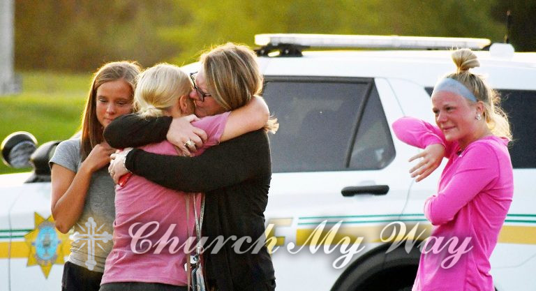 People console each other after a shooting at Cornerstone Church on Thursday, June 2, 2022 in Ames, Iowa. Two people and a shooter died Thursday night in a shooting outside a church in Ames, authorities said. (Nirmalendu Majumdar/The Des Moines Register via AP)