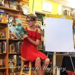 Bailey Harris looks down at the page during a book reading in 2018. Photo courtesy of Label Free Publishing